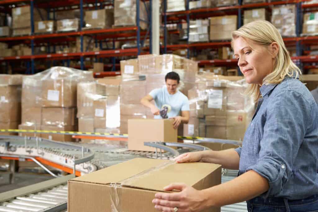 Woman holding a box in a warehouse