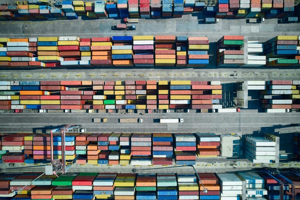 Rows of different-coloured shipping containers viewed from above